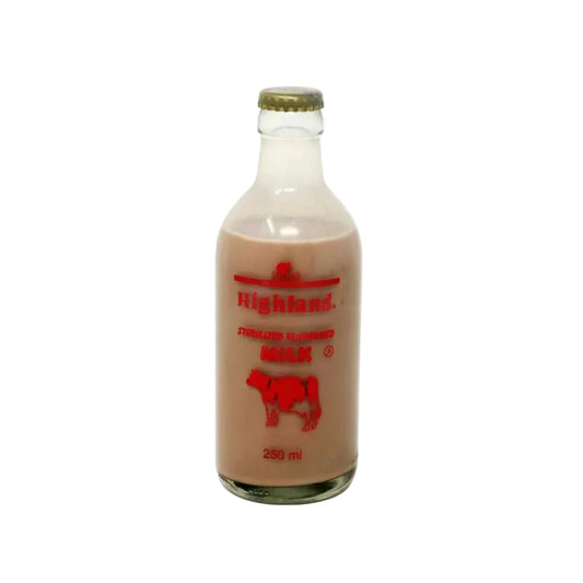 Bottle of Highland milk with a red label on a white background
