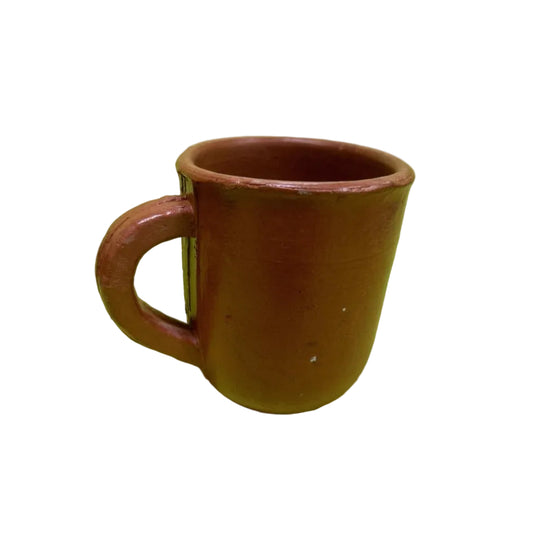 Terracotta mug on a green background
