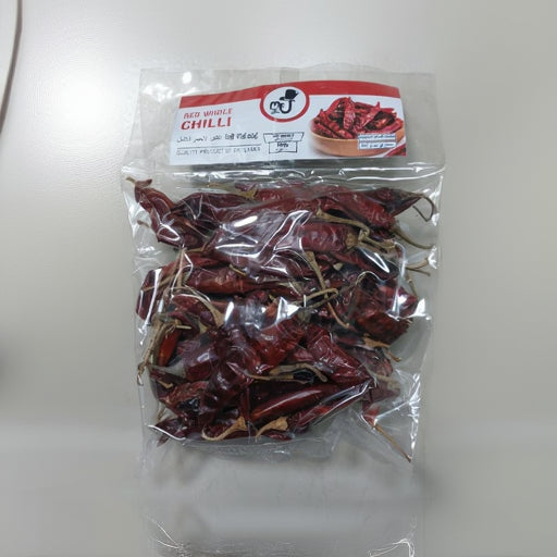 Packaged red chilies with a label on a white surface